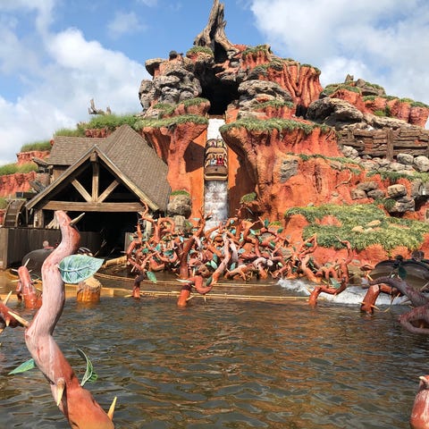 Guests scream through their masks on Splash Mounta