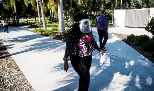Fort Myers resident Patrice Hardy enters Florida SouthWestern State College campus on Monday, July 13, 2020. Monday was the first day since the COVID-19 pandemic that students could come onto campus. They can meet with advisors, financial experts and others. COVID-19 precautions are being taken to keep students and staff safe. <em><a href="https://www.news-press.com/picture-gallery/news/coronavirus/2020/07/13/covid-19-florida-fsw-reopens-campus-person-student-services-photos/5431143002/" target="_blank">See more photos</a>. </em>
