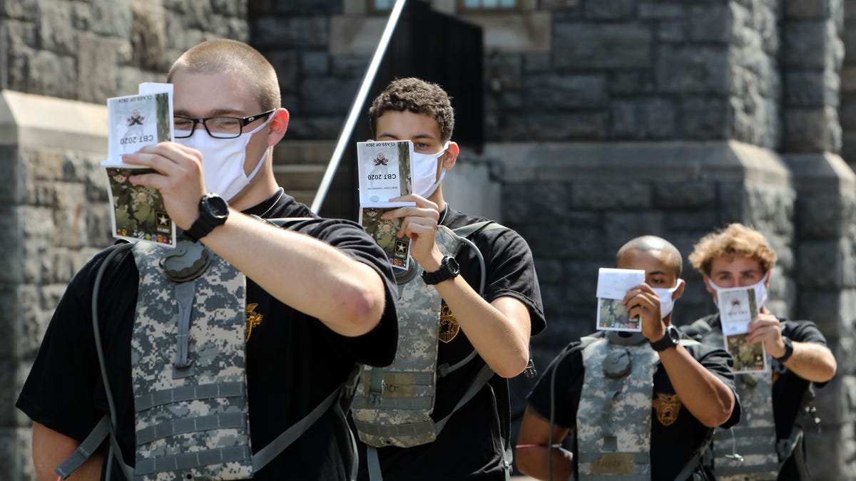 New cadets read the New Cadet Handbook between assignments during basic training at the U.S. Military Academy at West Point July 13, 2020 in West Point, N.Y. The 1,200-member class has been brought to campus in three separate reception days to accommodate public health guidelines. Candidates are COVID-19 tested immediately upon arrival, wear facial coverings and practice social distancing.