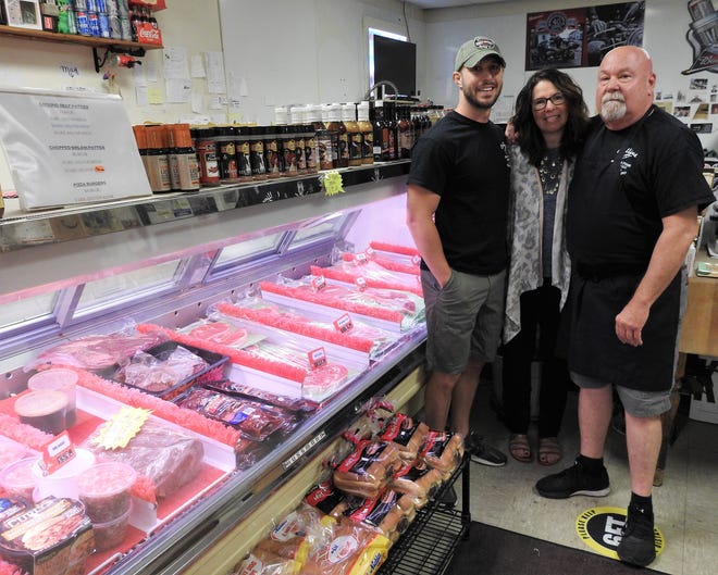 Sean, Toby and Gary Collins in front of the meat case at Collins Meat and Food Market on Kenilworth Avenue. The store celebrated its 40th anniversary this week. Gary said he doesn't look to retire anytime soon.