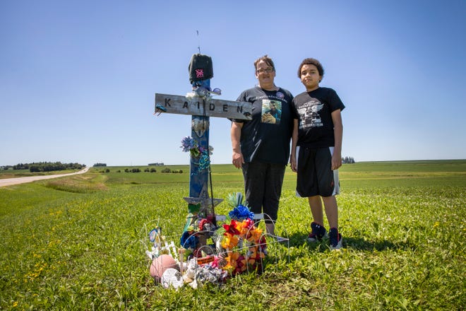 April Estling, Kaiden Estling's mother, and Amir Estling, Kaiden's brother, pose for a portrait next to Kaiden's memorial off of Iowa HWY 150 near Fayette on July 10, 2020. Amir and Kaiden were close growing up and struggled to process his death, April said.