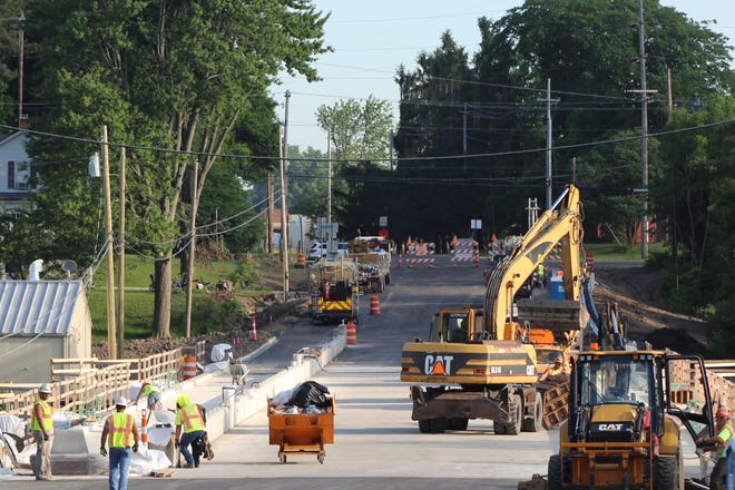 Contractors worked on the Elmore bridge project Tuesday morning. The Ohio Department of Transportation expects the bridge to be open to vehicle traffic later this month.
