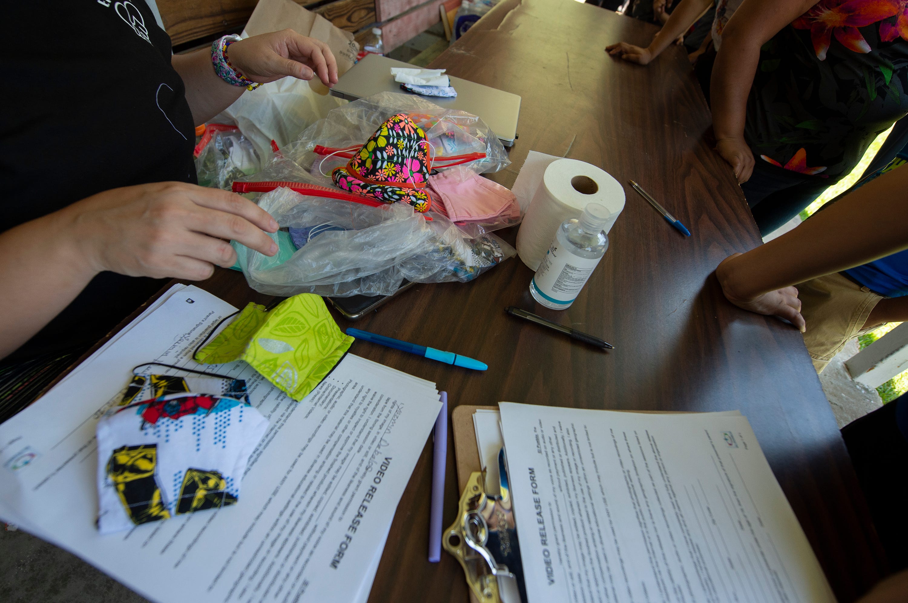 El Pueblo, a nonprofit specializing in immigration legal services, provides masks and hand sanitizer for people at a school supply distribution event in Forest, Miss., on July 11, 2020. In August 2019, the Latino community in Forest was hit hard by ICE raids at local poultry plants.