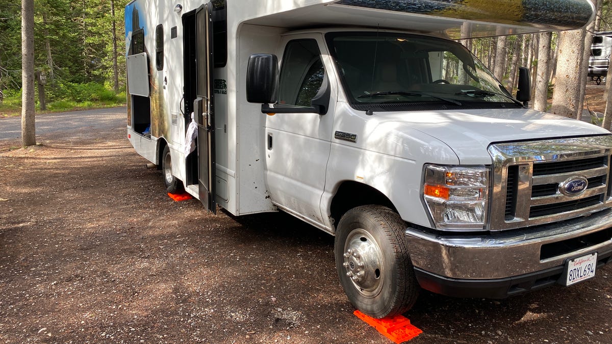 The RV is parked on blocks in order to stay level.