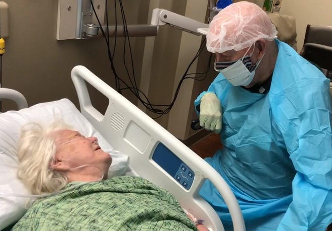 Sam Reck meets with his wife, JoAnn, for a final time Saturday night at Lakeland Regional Health Medical Center. JoAnn, 86, died Sunday after being diagnosed with COVID-19.