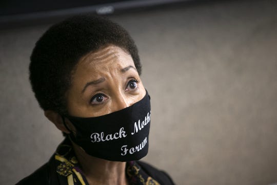 Janelle Wood, founder of the Black Mothers Forum, looks on during a press conference with Dion Johnson's family and their attorney, Jocquese Blackwell, at Blackwell's law office in Phoenix on July 16, 2020. Johnson was killed by Department of Public Safety trooper George Cervantes after he was found asleep in his car on the Loop 101 in Phoenix on May 25, 2020. The Phoenix Police Department released a report on July 15, detailing the criminal investigation into the fatal shooting.
