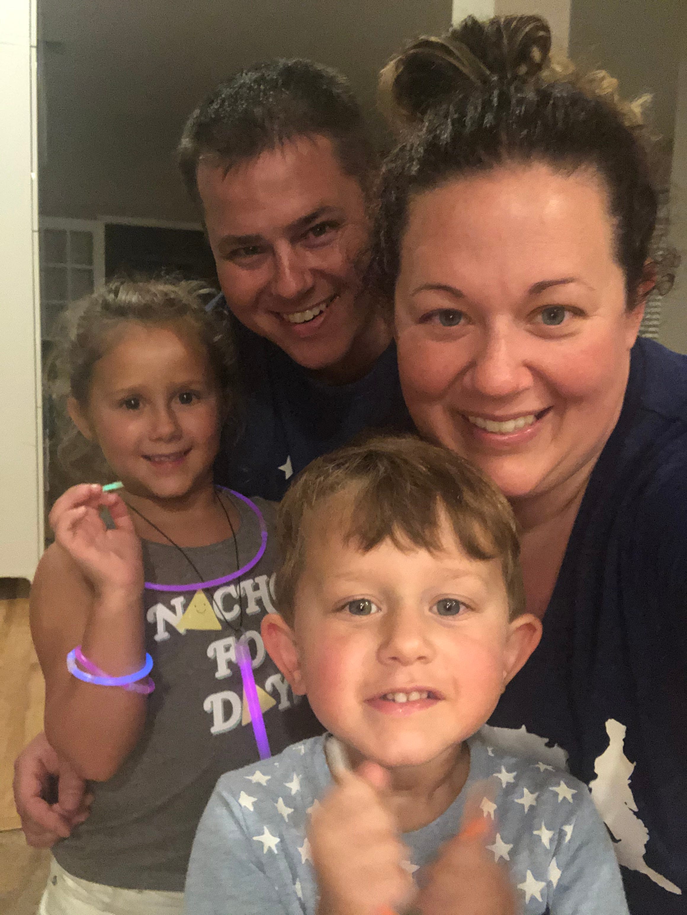 Jennifer Raymond, right, poses with her family for a selfie over the July 4 holiday. Oliver, 6, and Lily, 4, are both back at school and daycare as both parents work.
