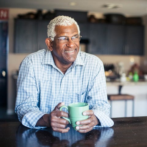 A senior enjoys a cup of coffee at home