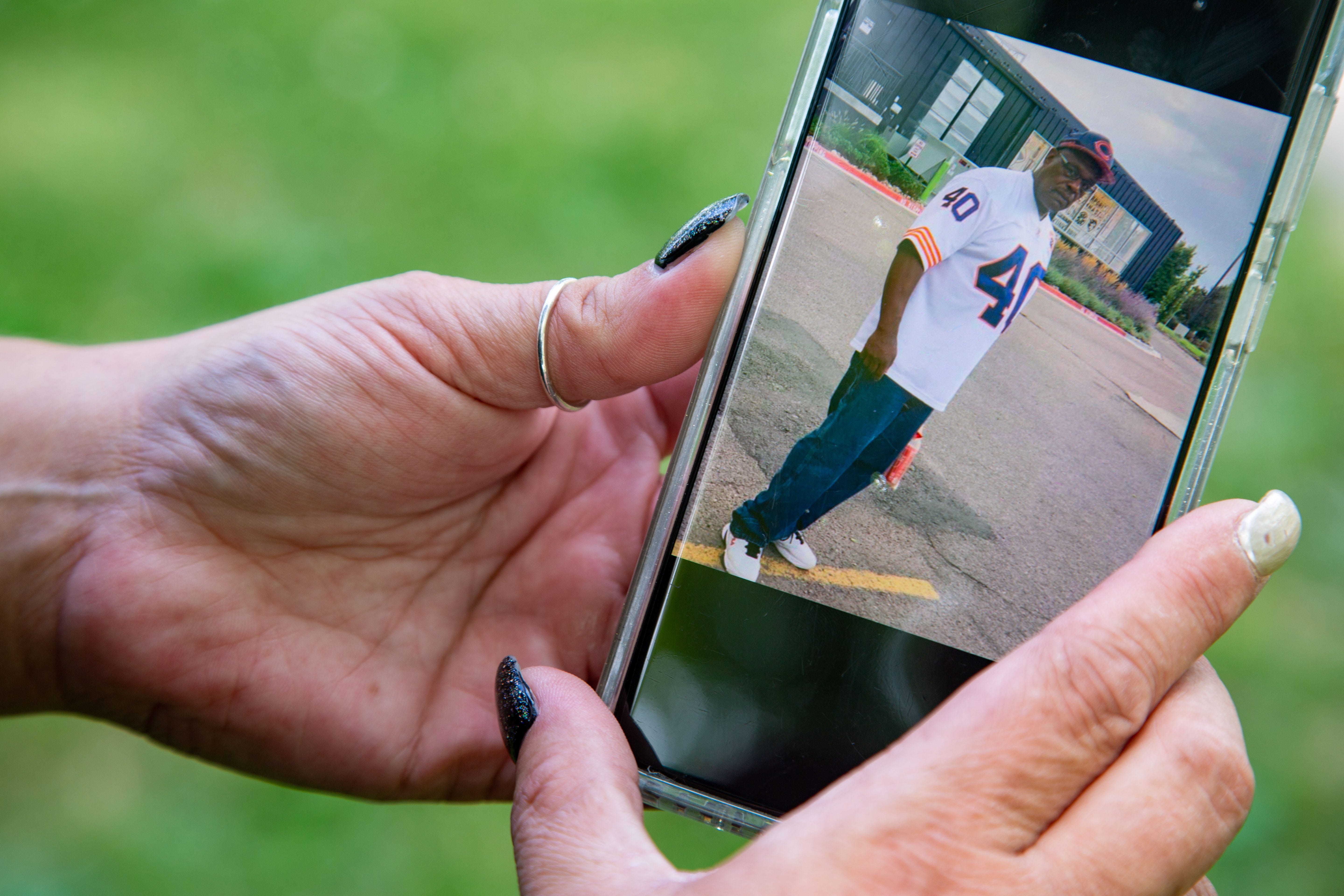 Sara Jones holds her phone with a photo of her late husband Kenneth Friday, July 17, 2020. Sara's husband Kenneth Jones died of COVID-19 in June.