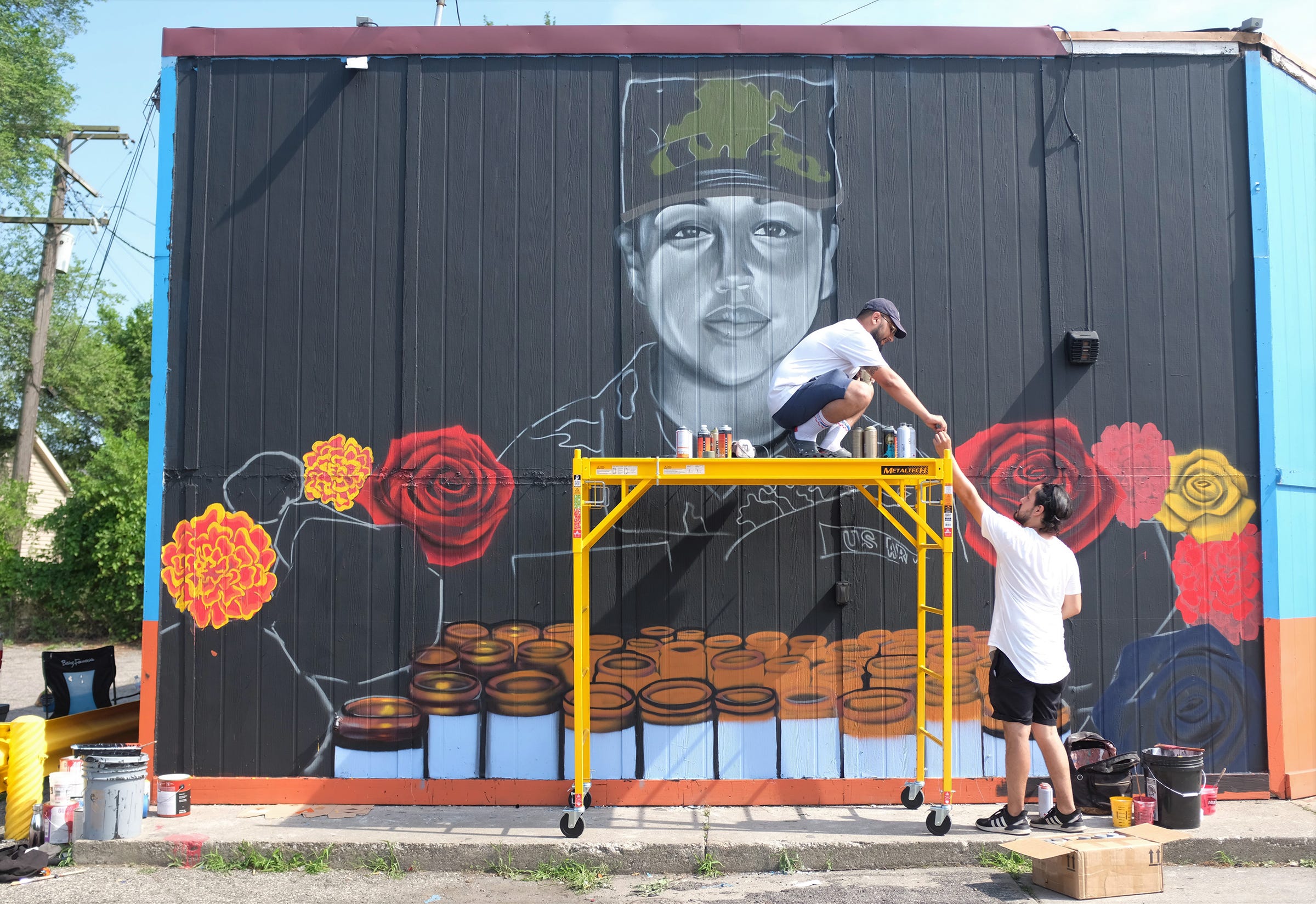 Muralist Freddy Diaz of Detroit creates a mural for Vanessa Guillen, the army soldier who went missing from Fort Hood, in Central Texas on April 22, 2020. With the help of Yahaira Gomez of Detroit who raised funds for the mural and Gabriel Martinez, the owner of Bodega Cat who allowed the mural to be painted on his building, the mural will be unveiled on Saturday.