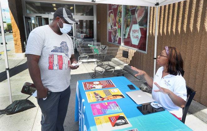 Rochester resident Junior Hutchins volunteers to help get the message out on the importance of filling out your Census card at a kiosk outside Tops Markets on West Avenue.  He will take part in a text messaging program to encourage Rochester residents to be counted. 