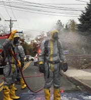 Piermont first responder being decontaminated following an emergency call to protect against the COVID-19 virus