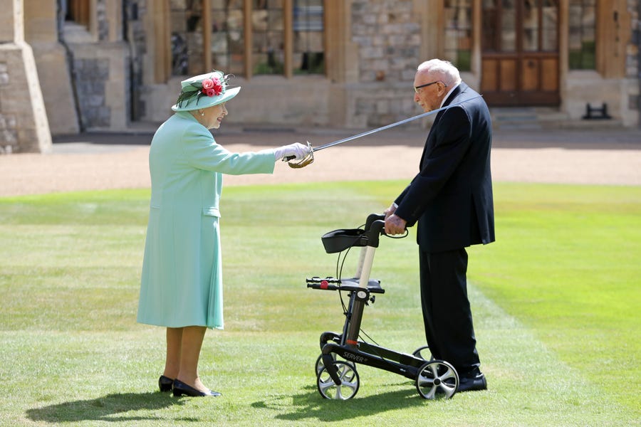 Queen Elizabeth II awards Captain Sir Thomas Moore with the insignia of Knight Bachelor at Windsor Castle on July 17, 2020.