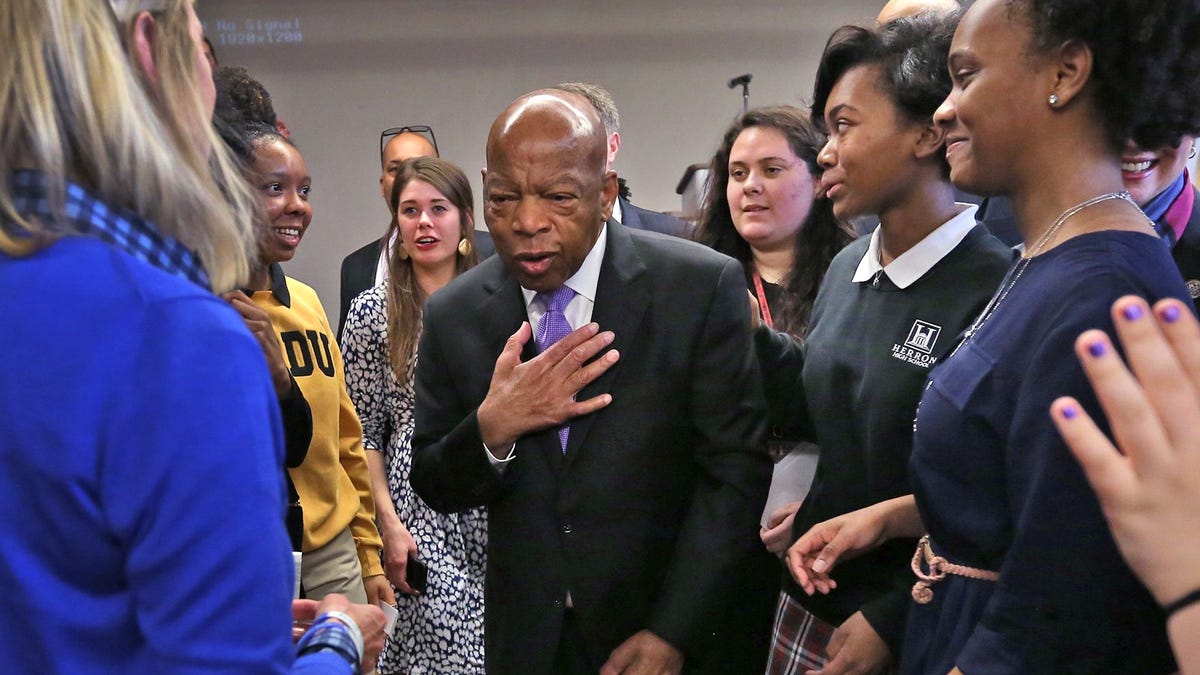 Rep. John Lewis (center) talks with Kerry Kennedy (left), daughter of Robert Kennedy, at an event with kids at 16 Park Community Center. The congressman joined Kerry Kennedy and other dignitaries for a day of activities for the remembrance of the Robert Kennedy speech in Indianapolis the night after Martin Luther King Jr. was assassinated.