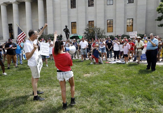 Lia Ivko of Newark, Ohio, rallies anti-mask protesters after her speech at the statehouse.