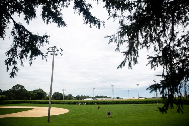 Tourists play catch in the outfield at the Field of Dreams movie site as construction continues on the stadium that will host the Chicago White Sox and St. Louis Cardinals in August, Monday, July 20, 2020, in Dyersville . 