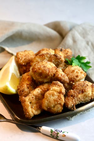 Fried Spanish mackerel nuggets are first marinated in buttermilk, breaded in a spicy cornmeal mixture, and then fried to perfection.