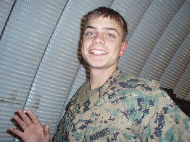 Scott Olsen smiles for a photo at Marine Corps Air Ground Combat Center Twentynine Palms in 2008.