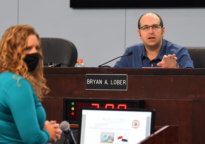 Brevard County Budget Director Jill Hayes answers a question during Tuesday's County Commission meeting. On the dais is County Commission Chairman Bryan Lober.