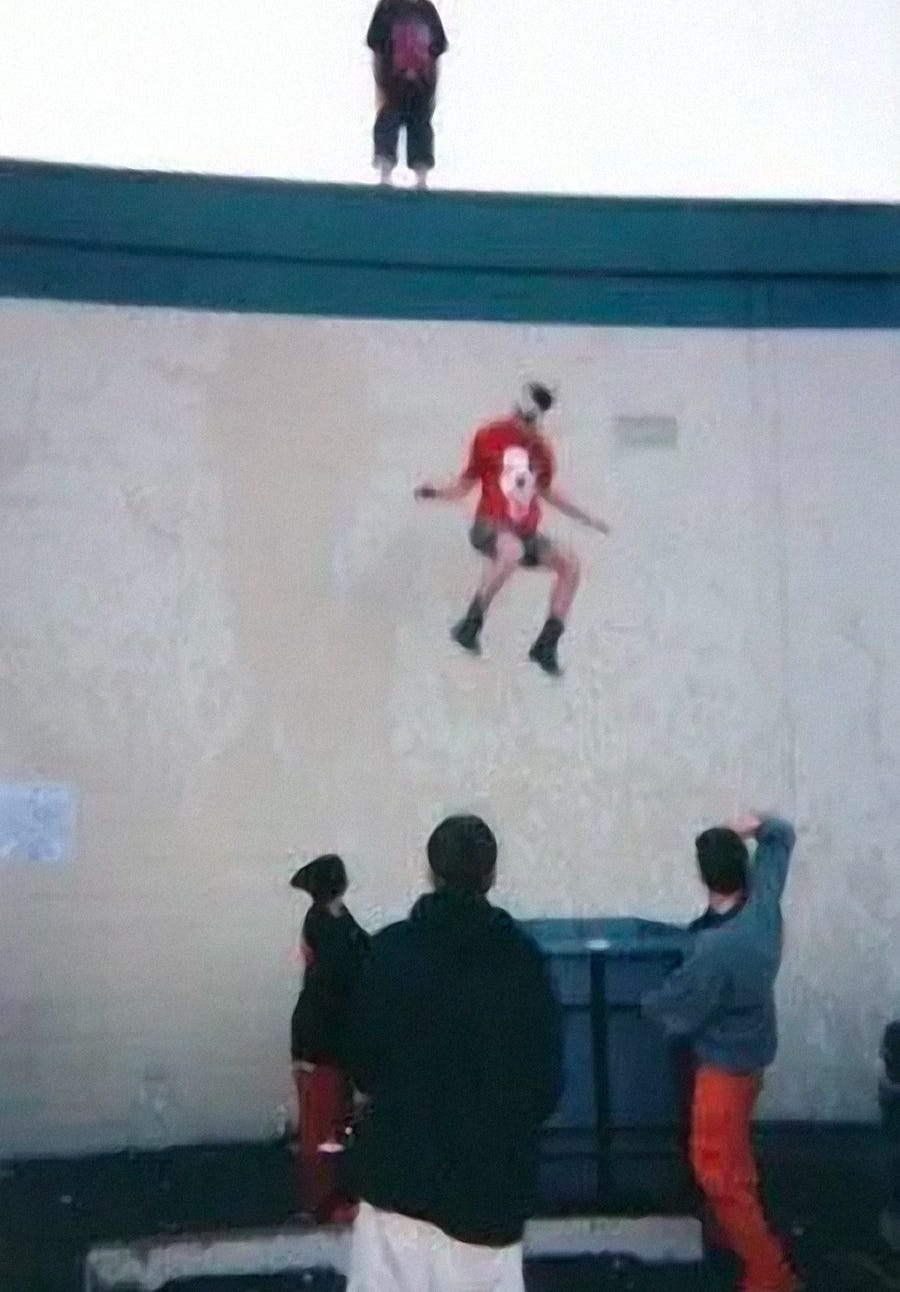 A fan jumps off of the roof into a dumpster at the first Gathering of the Juggalos festival.