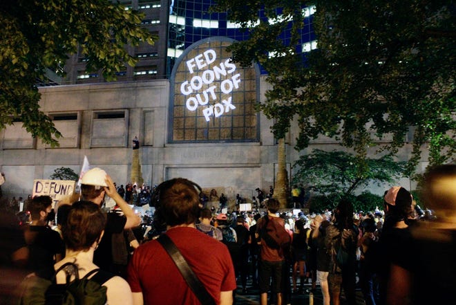 Protesters projected words on the front of the Multnomah County Justice Center July 20 in Portland, Ore.