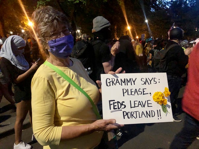 Mardy Widman, a 79-year-old grandmother of five, protests the presence of federal agents outside the Mark O. Hatfield Federal Courthouse in Portland, Oregon, Monday, July 20, 2020. Widman said this was her first time protesting since George Floyd’s death because of her fear of the coronavirus but the Trump administration’s decision to send federal agents to Portland motivates her to come.