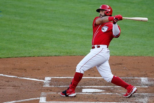 Cincinnati Reds third baseman Eugenio Suarez (7) follows through on a swing as he grounds out to Detroit Tigers third baseman Jeimer Candelario (46) in the first inning of a preseason game between the Cincinnati Reds and the Detroit Tigers at Great American Ball Park in downtown Cincinnati on Tuesday, July 21, 2020.