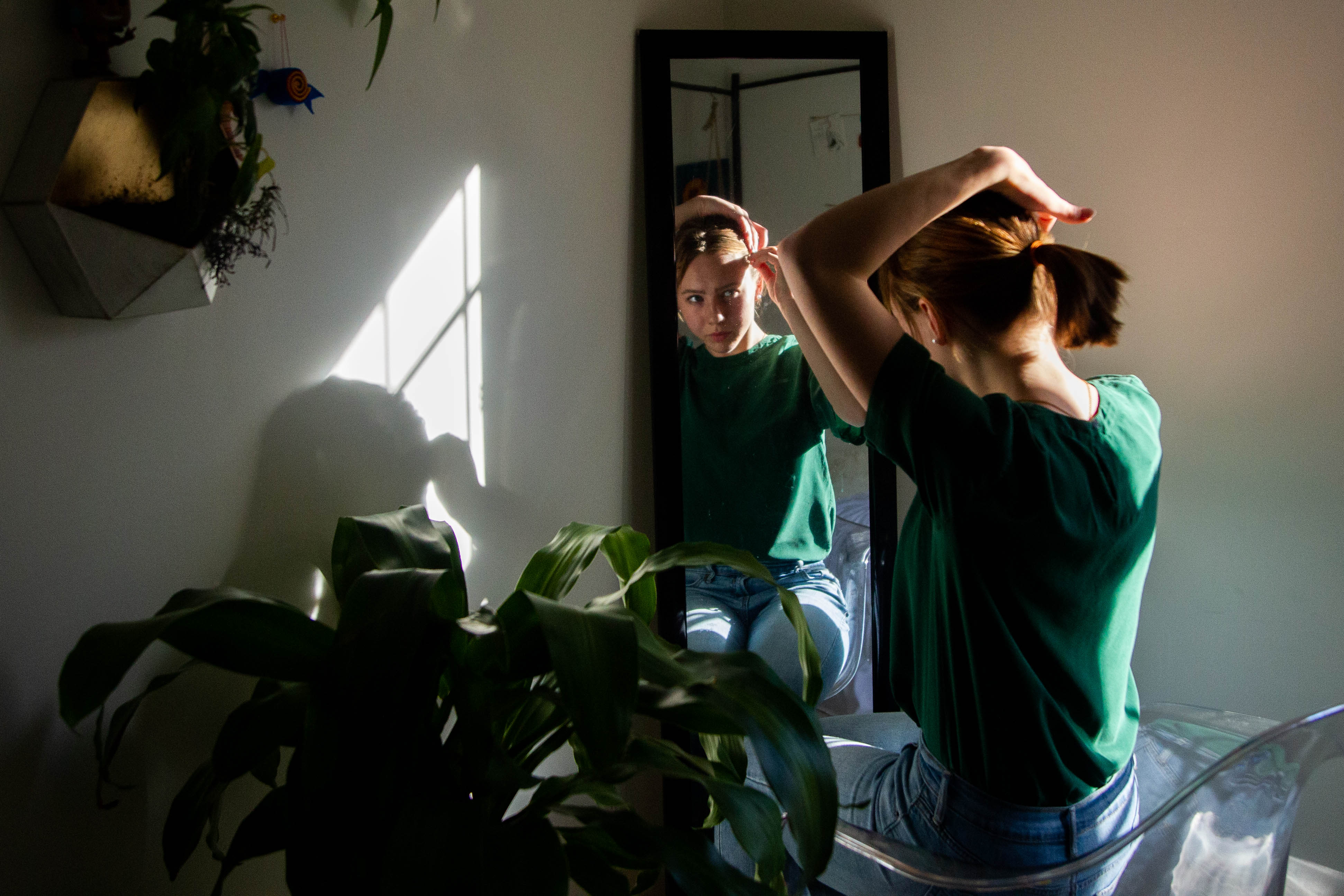 Macayle McMullin gets ready for a ballet class Jan. 7 in her room.