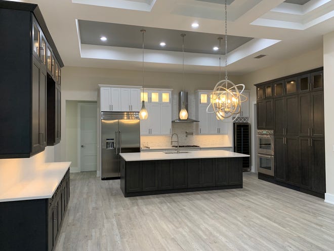 The kitchen in the recently completed custom home by Cintron Custom Builders boasts a ten foot island that allows for comfortable, large family dining.