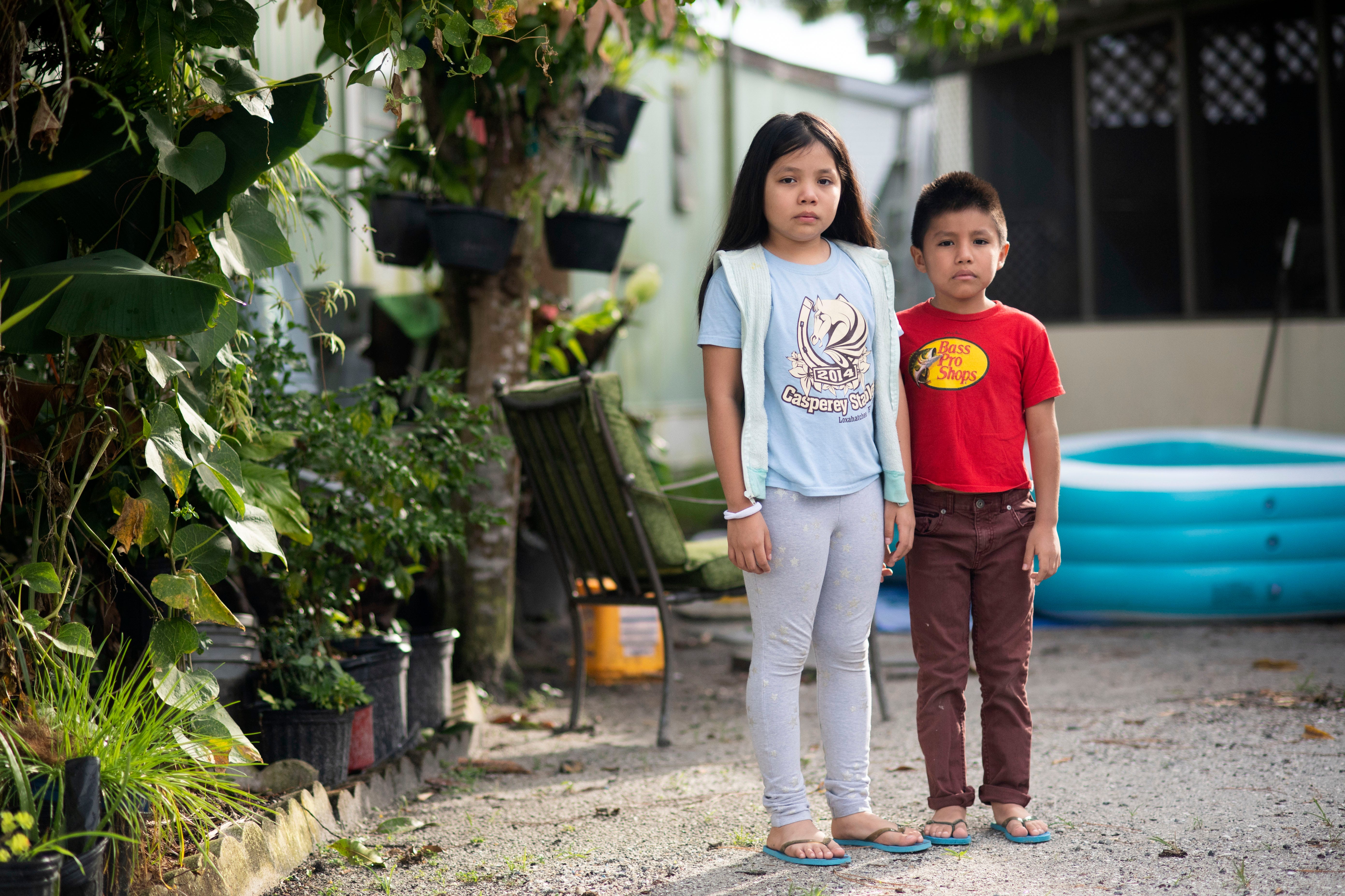Siblings Jessica Tzul, 9, and Freddy Tzul, 7, are students at Warfield Elementary School in Indiantown, Florida. Their father, Freddy Vasquez, has decided to enroll the elementary students and his two high-school-age children through the virtual learning option and to send them back to campus only when COVID-19 cases decline. "I don't agree with reopening schools," Vasquez said. "The situation is getting worse, and sending kids back to school will make it worse."