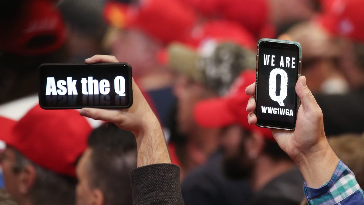 Supporters of President Donald Trump hold up their phones with messages referring to the QAnon conspiracy theory at a campaign rally at Las Vegas Convention Center on February 21, 2020 in Las Vegas, Nevada.