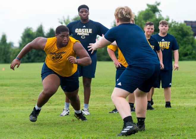 Castle defensive lineman Jaden Allen (left) runs a drill during practice on Thursday. He hopes to lead the Knights into contention for the SIAC title.