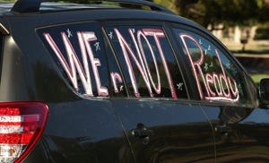Teachers take part in a "motor march" at Encanto Park in Phoenix on July 22, 2020, to protest reopening K-12 schools for in-person classes.