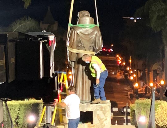 The statue of Father Junipero Serra gets removed this morning in front of Ventura City Hall. 