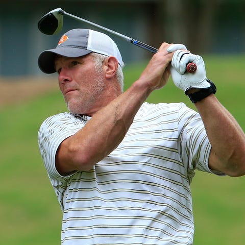 Brett Favre hits his drive on the 12th hole during