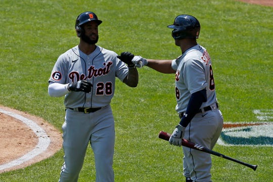 Detroit Tigers shortstop Niko Goodrum (28) fist bumps with second baseman Jonathan Schoop after a solo home run in the third inning vs. the Cincinnati Reds at Great American Ball Park in Cincinnati on Sunday, July 26, 2020.