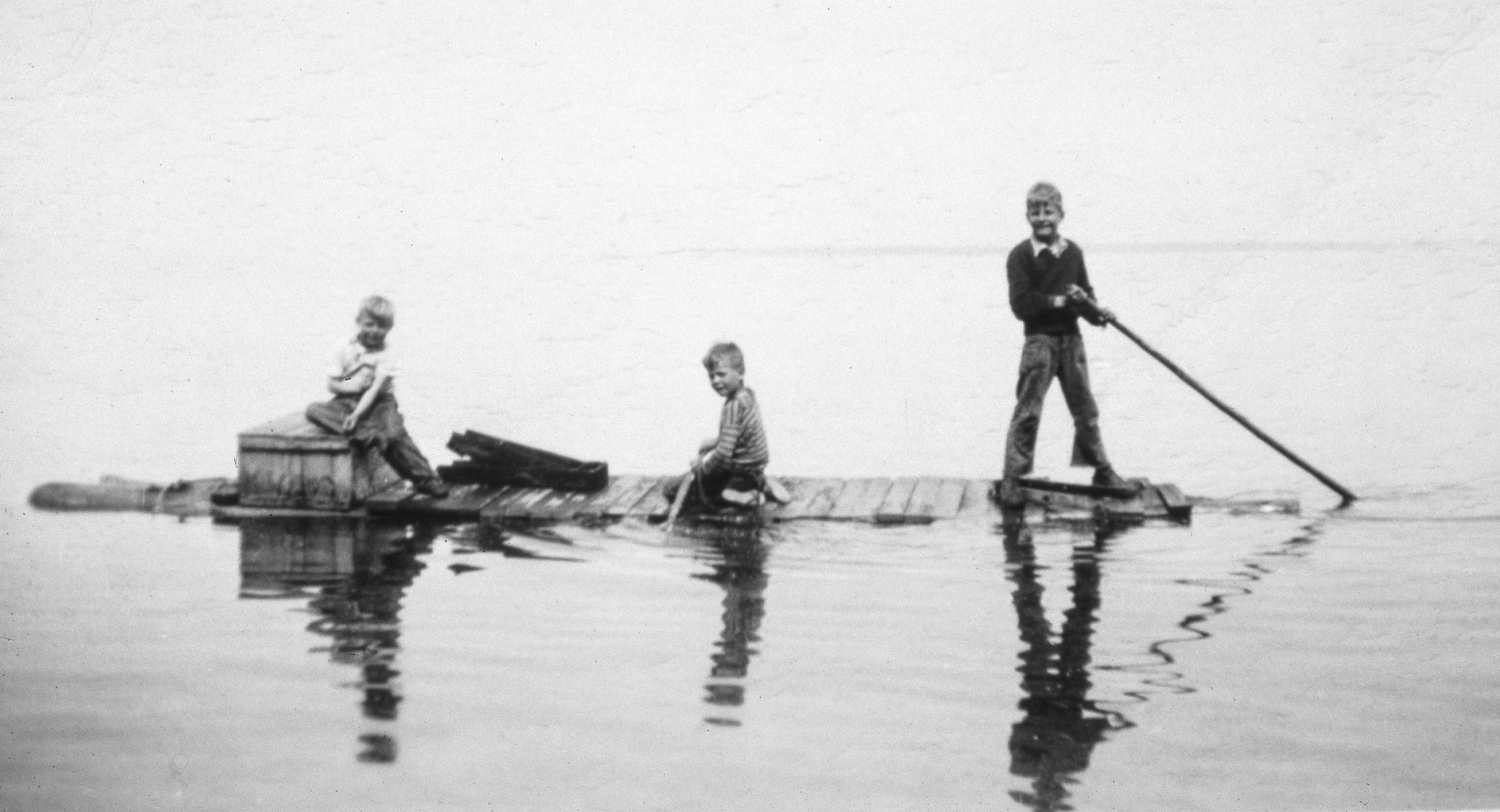 Bob Dahl, center at age 6, his brother Carl Dahl  Jr,. right at age 9, and cousin Paul Hansen, left, explore Lake Superior at Sand Island in 1948 on a raft fashioned from salvaged materials. The Dahls lived on a property on Sand Island before the Apostle Islands became a national lakeshore in 1970.