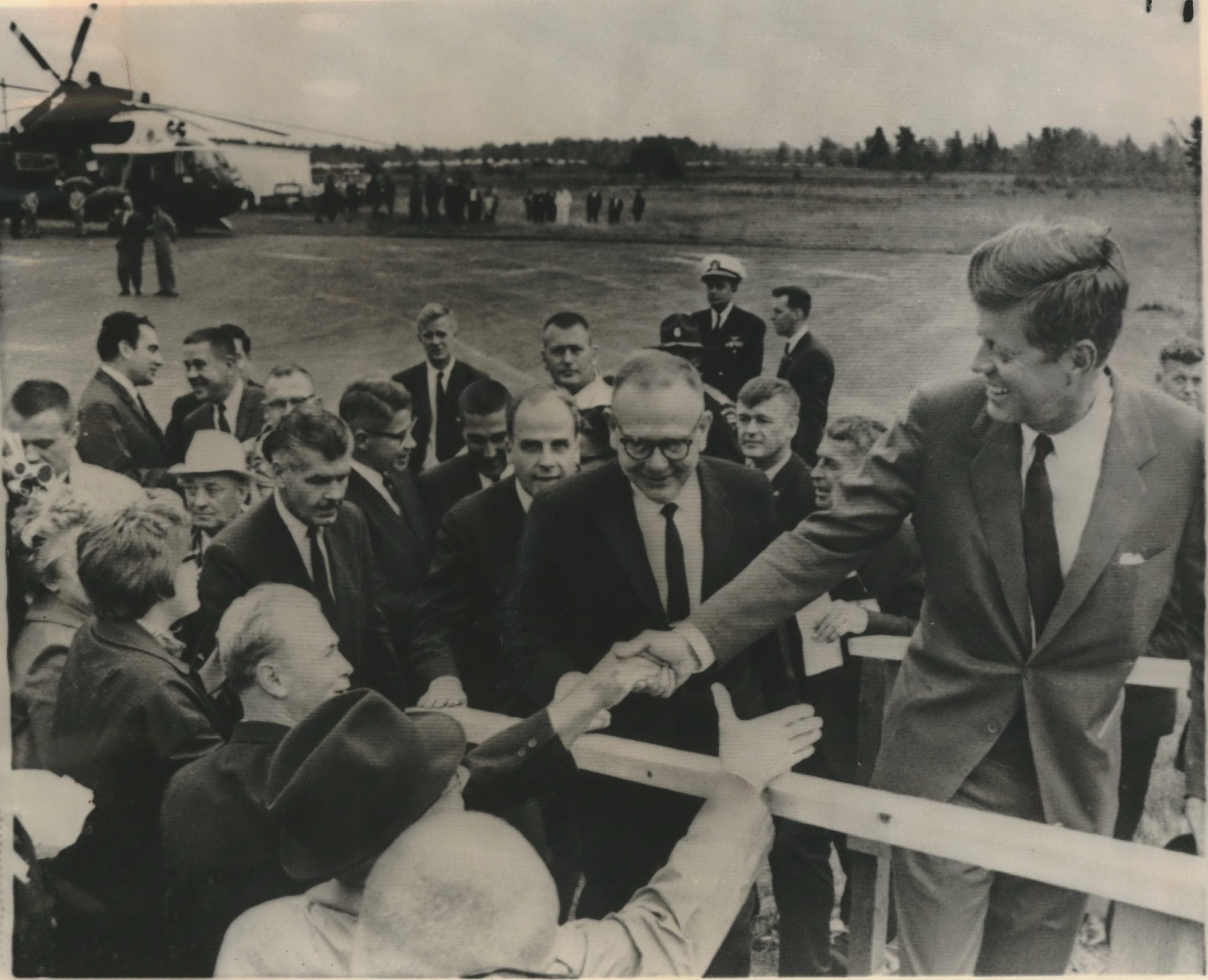 President John F. Kennedy shook hands with people in the crowd on Sept. 24, 1963 as he mounted the stairs to the speakers' platform at the Ashland airport after a helicopter tour over the Apostle Islands. Following him were Governor Reynolds, Senator Nelson, Interior Secretary Udall and Agriculture Secretary Freeman. The president spoke briefly before going back to Duluth, Minn.