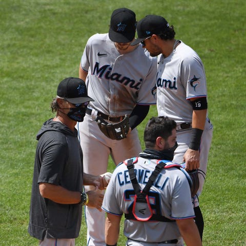 Miami Marlins manager Don Mattingly (left) stands 