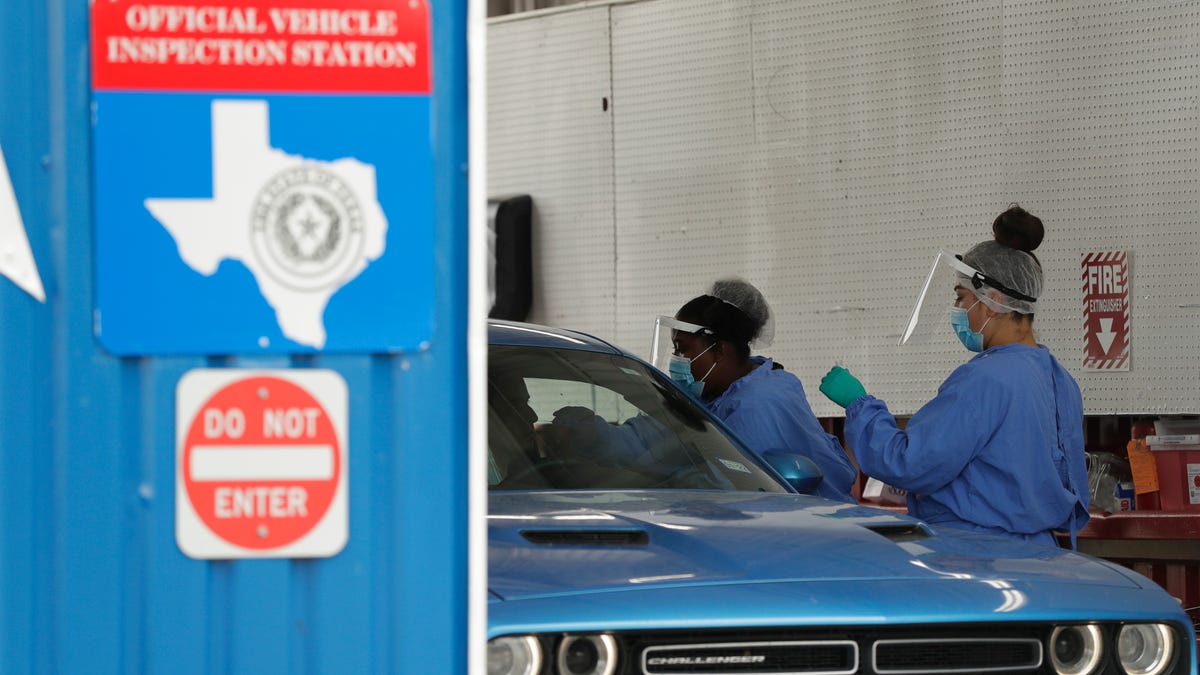 COVID-19 antibody testing and diagnostic testing are administered at a converted vehicle inspection station, Tuesday, July 7, 2020, in San Antonio. Local officials across Texas say their hospitals are becoming increasingly stretched and are in danger of becoming overrun as cases of the coronavirus surge.
