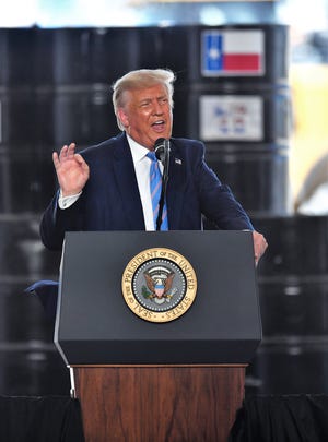 President Donald Trump speaks inside a tent but near oil field rigs Wednesday south of Midland. It was his first visit as president to West Texas, where overwhelmingly supported his election in 2016.