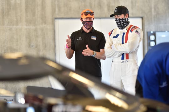 Seven-time NASCAR series champion Jimmie Johnson (right) tested an Indy car for the first time Tuesday, with the help of Chip Ganassi Racing veteran Scott Dixon.