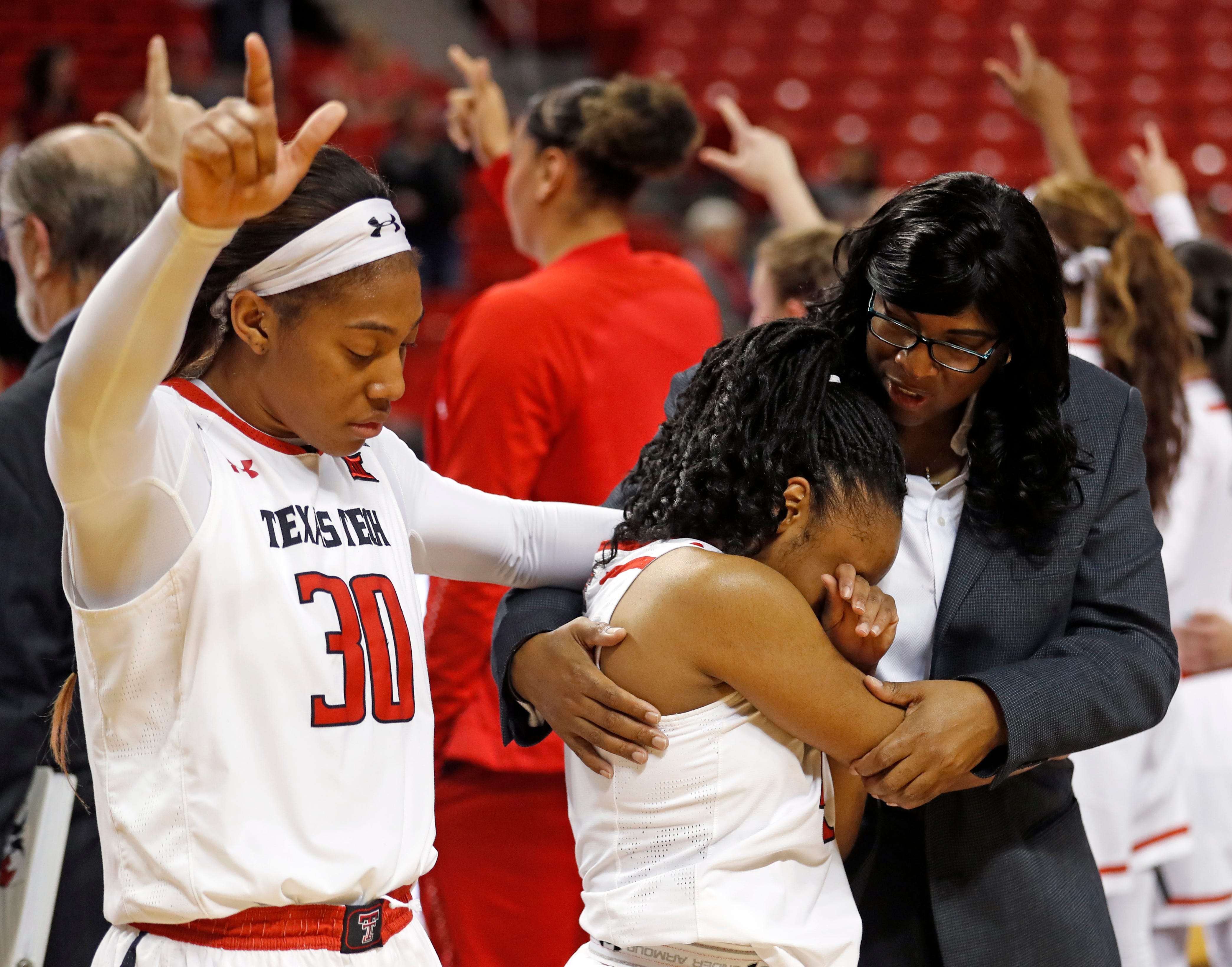 Texas Tech assistant coach Nikita Lowry Dawkins, right, holds Chrislyn Carr after she missed a potential game-winning shot after a game in February 2019.