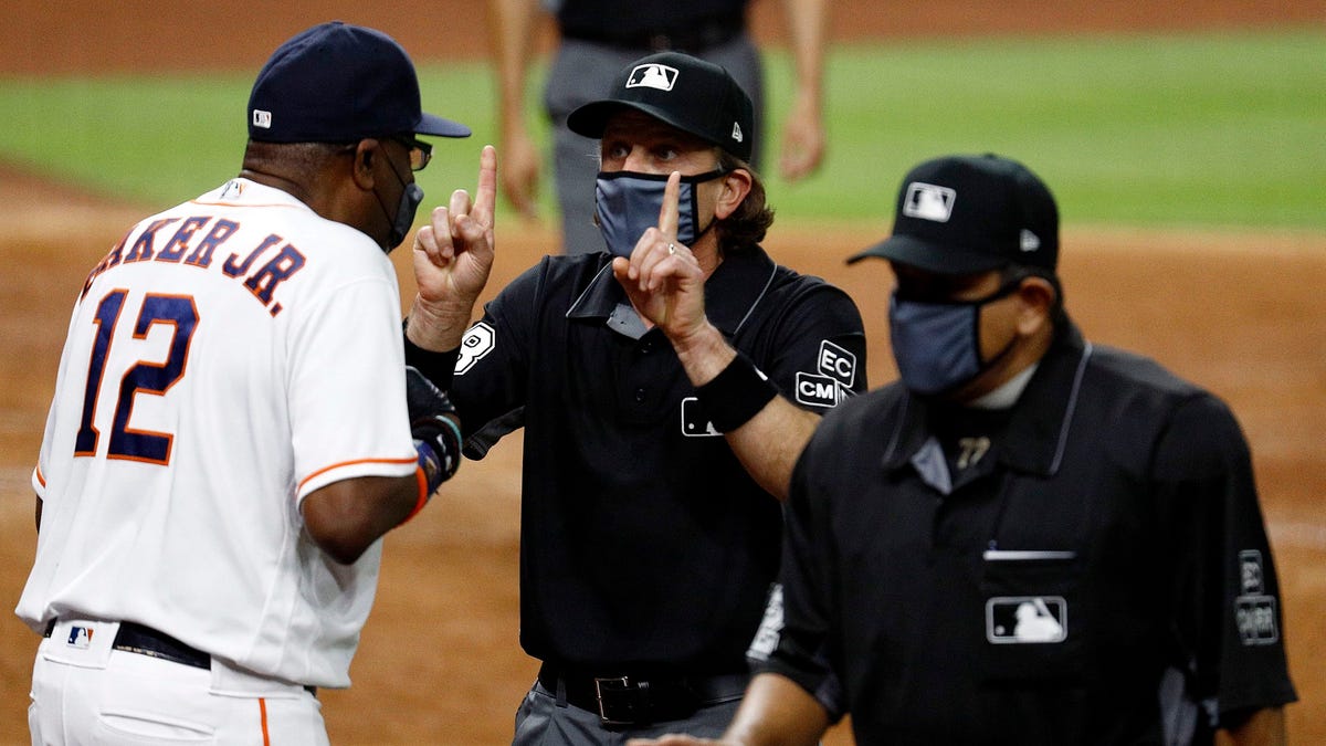 Houston Astros manager Dusty Baker speaks with umpires Chris Guccione and Alphonso Marquez after benches emptied after the sixth inning.