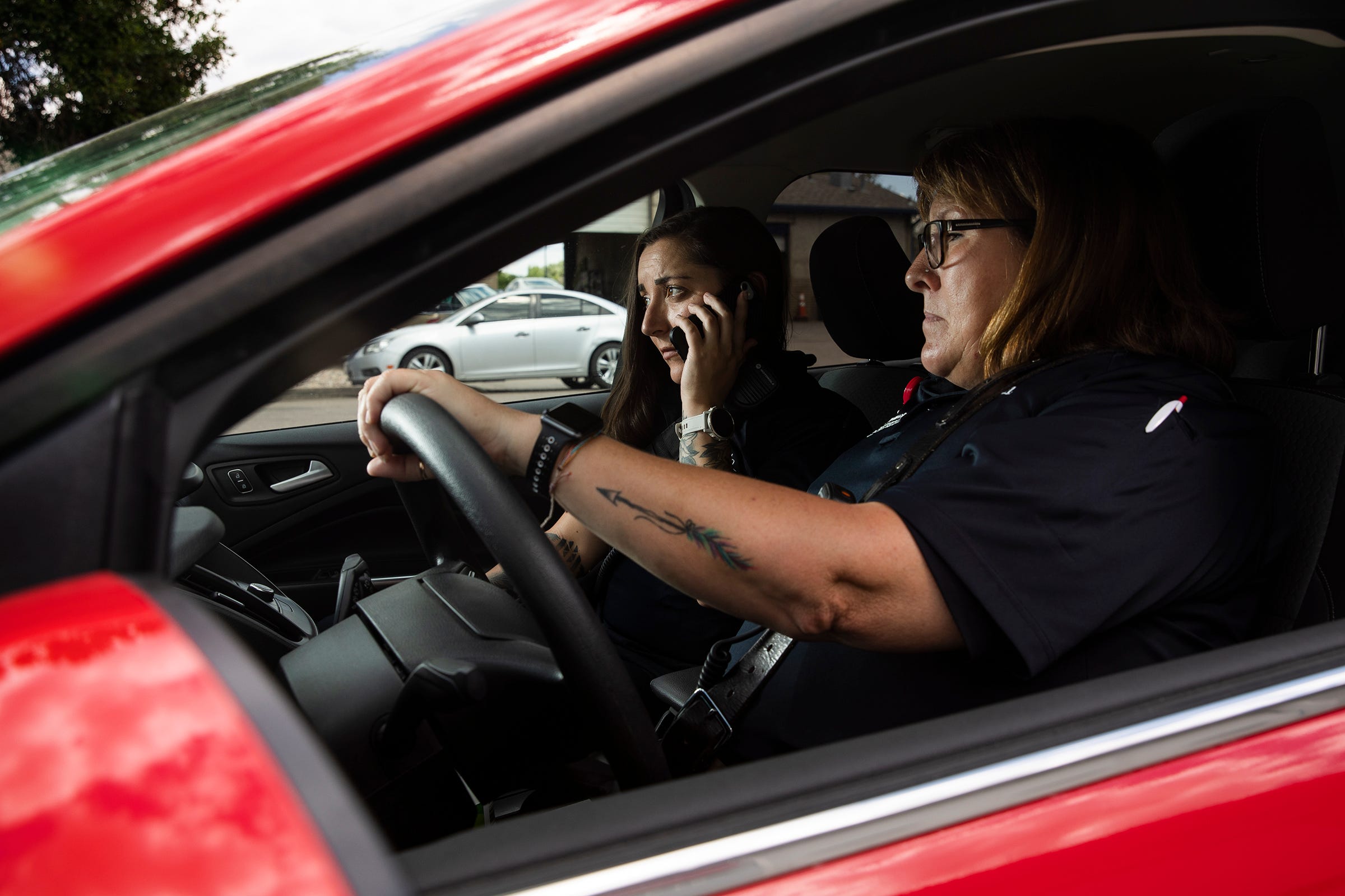 UCHealth community program coordinator and licensed clinician Stephanie Booco, left, and community paramedic Julie Bower take a call from Fort Collins Police Services.