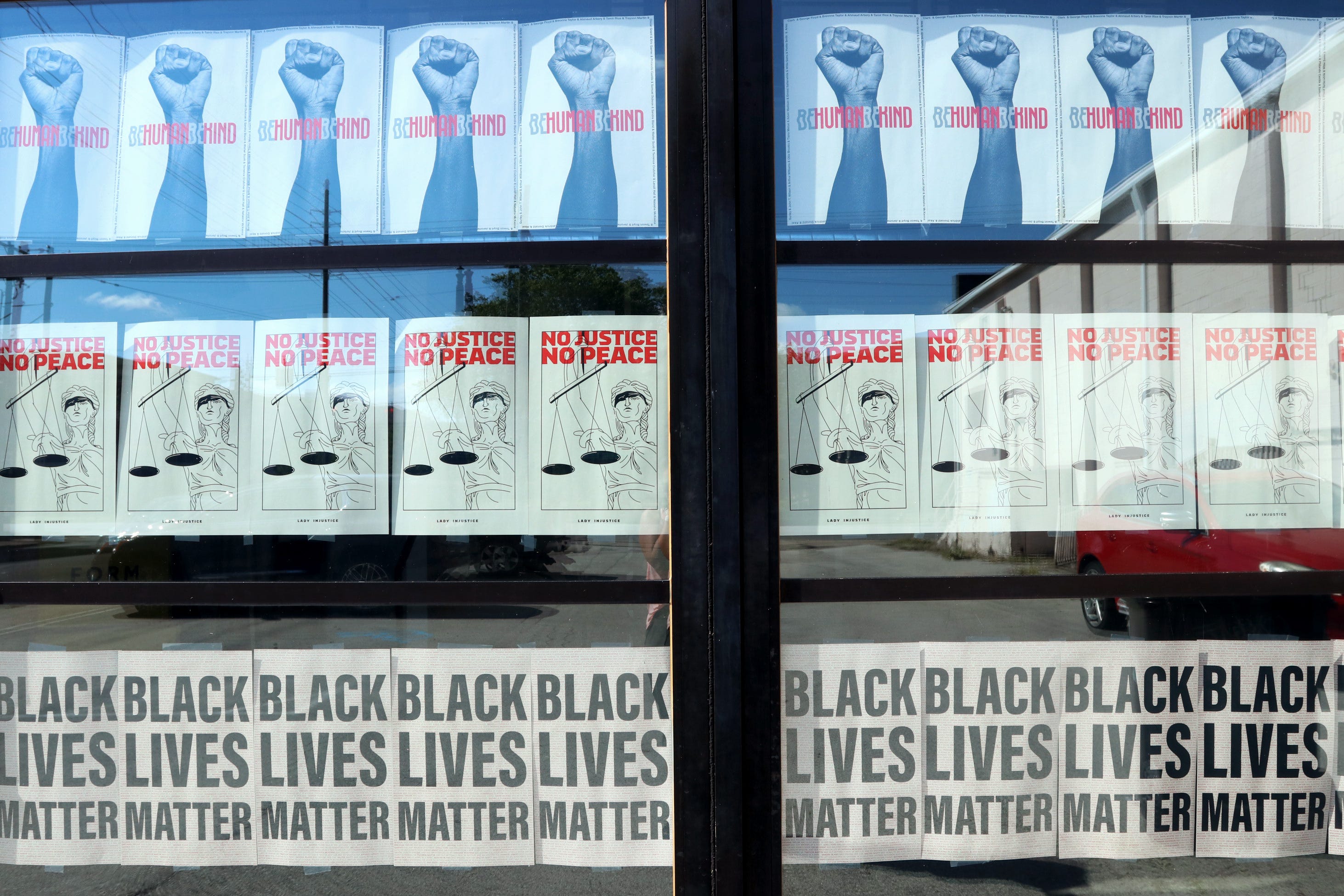 Black Lives Matter signs and paintings adorn the windows of businesses in NuLu, a small commercial district in downtown Louisville.