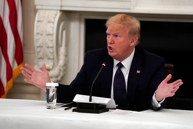 President Donald Trump tells reporters that he is taking zinc and hydroxychloroquine during a meeting with restaurant industry executives about the coronavirus response, in the State Dining Room of the White House, May 18, 2020, in Washington.