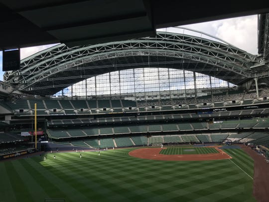 Brewers players are shown warming up on Friday, July 31, 2020 at Miller Park in Milwaukee, Wis.  The Milwaukee Brewers' scheduled home opener Friday afternooon at Miller Park against St. Louis has been postponed because of positive coronavirus tests with the Cardinals travel party.