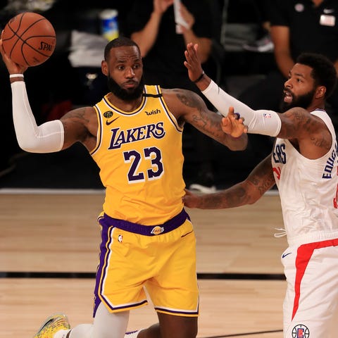 LeBron James passes the ball as the Clippers' Marc