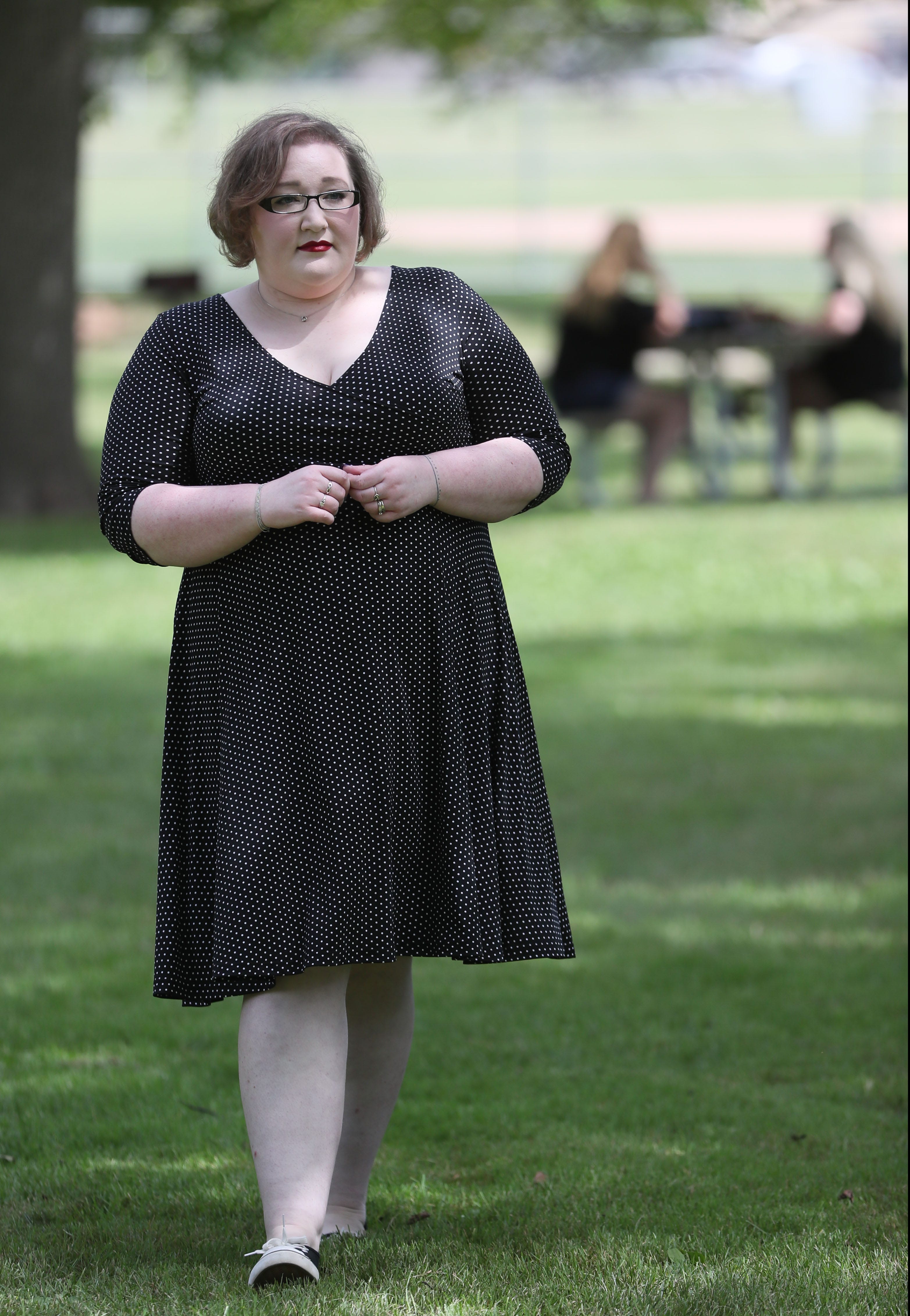 Leah Blomberg of Muskego, still feeling after effects of COVID-19, takes a walk in a park near her Muskego home.